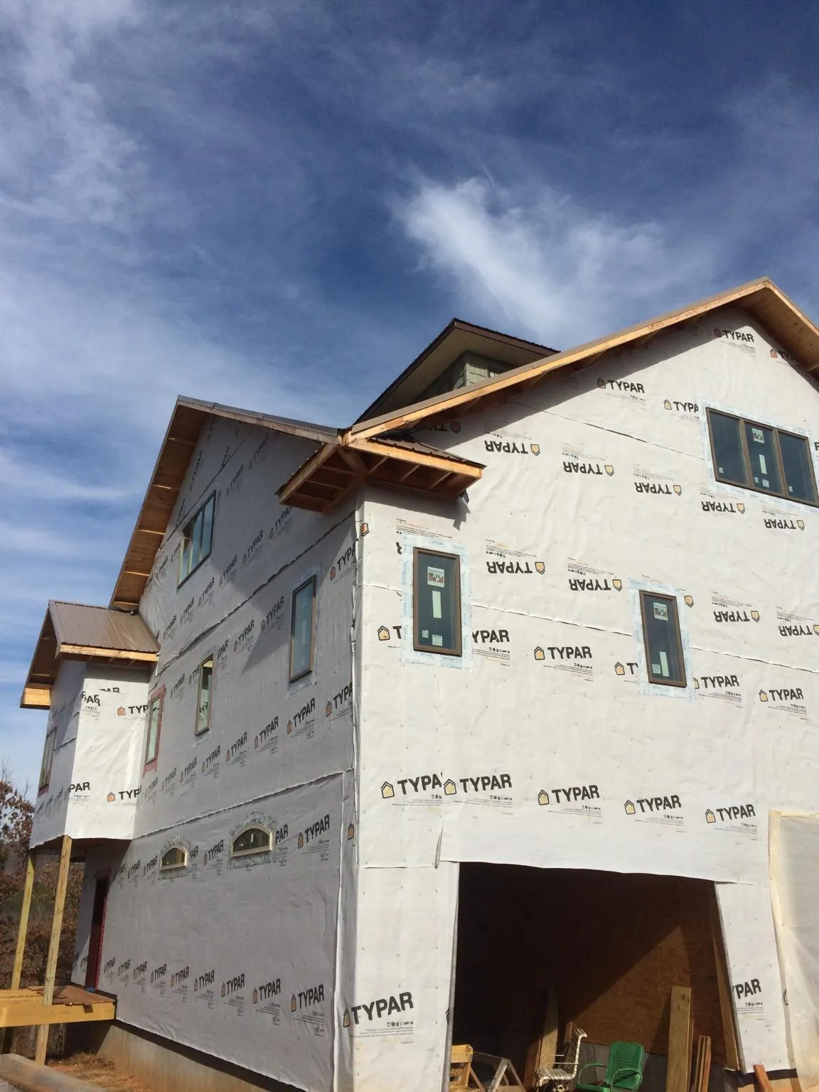 Stick built house wrapped in Typar with new roof framing and dormers in Brevard